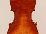 an antique violin with a wooden back and a wooden bow