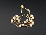 un gros plan d'un bracelet orné de perles sur un fond noir