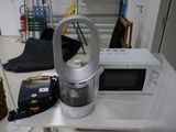 a coffee maker and a microwave sitting on a table