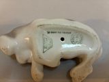 porcelain figurine of a cow with a tag on it ' s back
