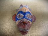 a mask on the wall of a man ' s face