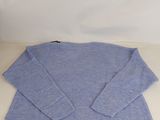 a blue sweater sitting on top of a white table