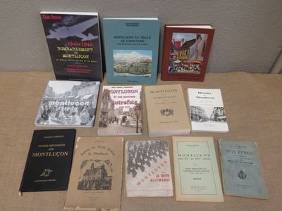 several books are sitting on a table in front of a wall