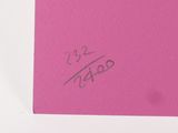 someone is writing on a pink piece of paper with a pen