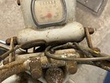 a close up of a motorcycle with a meter on the handlebars