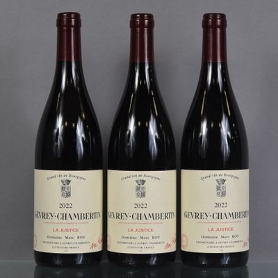 three bottles of wine are lined up on a table