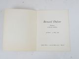 a close up of an open book on a white surface