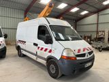 two vans parked in a warehouse with a crane on top of them