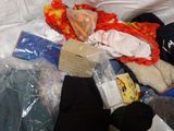 a pile of clothes and other items on a bed