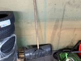 a pile of tires and a broom on a pallet
