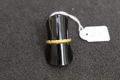 a ring that is sitting on top of a black object