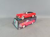 a red toy car sitting on top of a box