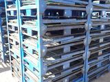 many pallets stacked on top of each other in the dirt