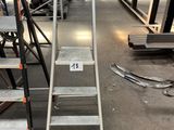 a lot of ladders that are in a warehouse