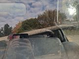a man taking a picture of himself in the back seat of a car