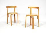 une paire de chaises en bois sur fond blanc, avec une toile de fond blanche