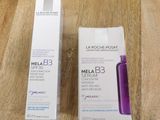 two bottles of melab 3 serum sitting on top of a wooden table