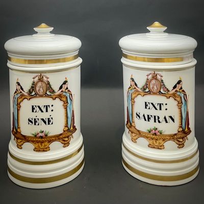two white and gold canisters with a picture of a man and a woman on them