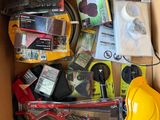 a cardboard box filled with assorted electronics and other items
