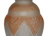 a white vase with a brown design on it