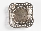 a silver plate with a decorative design on it