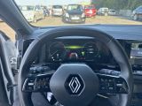 a steering wheel and dashboard of a car on the road