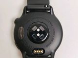 a close up of a watch on a white surface