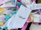 a pile of clothing and a tag on a table