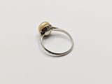 a close up of a silver ring with a pearl on it