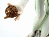 a figurine of a woman holding an apple
