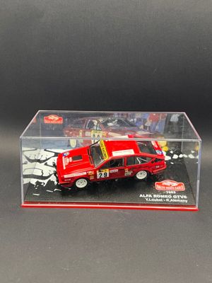 display case with a red car in it on a black surface