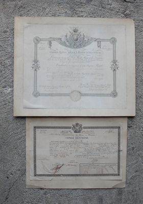 two old papers on the wall with a picture of a crown