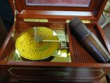 a wooden box with a musical instrument inside of it