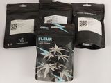 three bags of fleur tea sitting on top of a white table