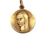 a close up of a gold medal with a woman ' s face on it