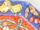 a plate with a painting of a fish and fruit on it