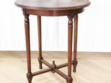 an old wooden table with a wooden top on a hard wood floor