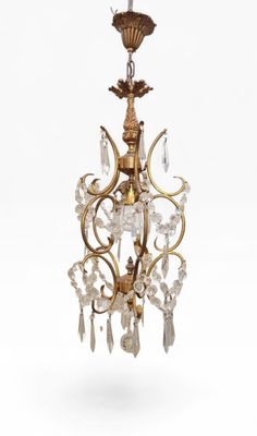 a gold and crystal chandelier hanging from a ceiling