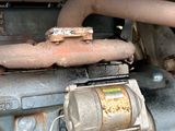 a close up of an old engine with a rusted cover