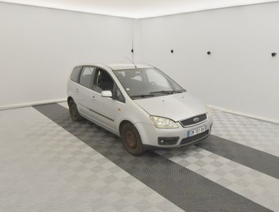 une petite voiture blanche garée dans une pièce blanche