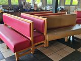 tables and benches in a restaurant with a checkered floor