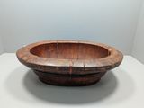 wooden bowl on a table in a room with a wall in the background