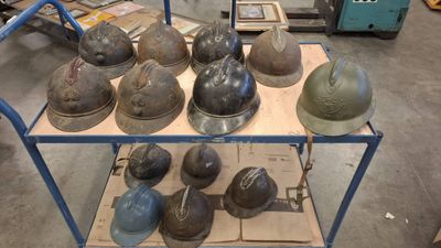 many helmets sitting on a cart in a warehouse