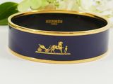 a close up of a blue and gold plate with a horse drawn on it