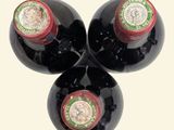 three bottles of wine are stacked on top of each other