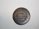 an old coin that is on a white surface
