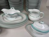 many plates and cups and saucers on the table