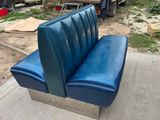 a blue couch that is sitting on a concrete slab