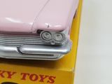 a pink toy car that is sitting on top of a box