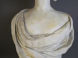 a statue of a woman that is wearing a shawl